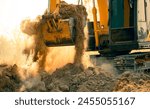 Close-up of excavator at construction site. Backhoe digging soil for earthwork and construction business. Excavating machine at work. Heavy machinery for earth moving and construction site development