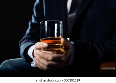 Closeup Of Executive Holding  Whiskey To Illustrate Executive Privilege Concept