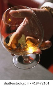 Closeup Of Executive Holding Whiskey To Illustrate Executive Privilege Concept