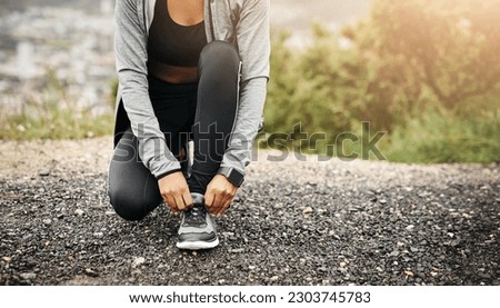 Closeup, exercise and woman outdoor, tie shoes and training with fitness, workout goal and target. Female person, athlete and runner with marathon, practice and sports with wellness, start and health