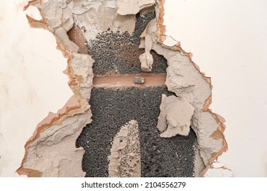 Close-up of exposed concrete block wall. Removing plasterboard from wall.  - Shutterstock ID 2104556279