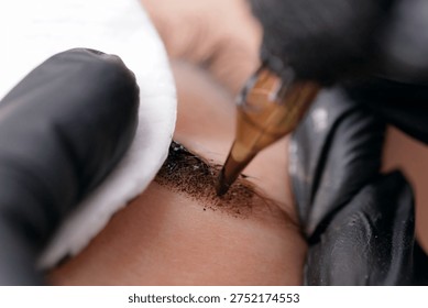 Closeup of eyebrow microblading process on skin, point Permanent.