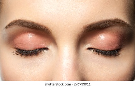 Close-up eyes closed with makeup with brown eyebrows and black lashes - Powered by Shutterstock