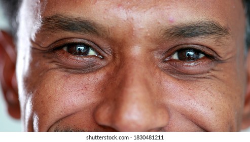 Close-up face african descent closing and opening eyes, smiling reaction