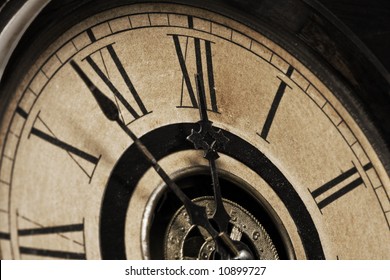 A Close-up Of The Face Of An Antique Grandfather Clock That Is Going To Strike Midnight Shortly