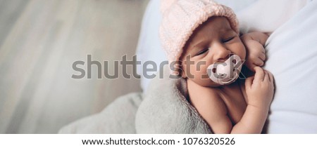 Closeup  of baby girl with pacifier sleeping