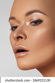 Close-up Face Of Beautiful Young Woman With Smooth Tanned Skin. Portrait Of Beauty Model With Natural Bronze Make-up. Spa, Skincare And Wellness