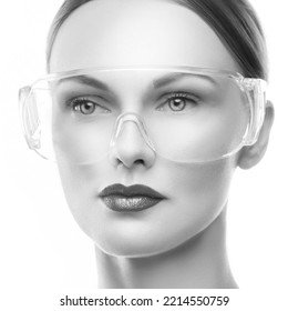 Close-up Face Of Beauty Cosmetology Doctor Woman Wearing Medical Protective Glasses, Perfect Skin, Makeup. Monochrome