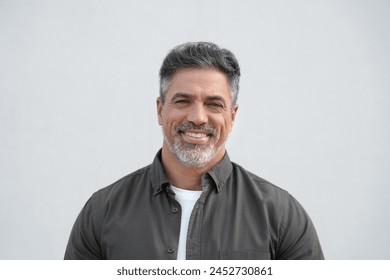 Closeup face headshot portrait of middle age mature adult man. Freelancer entrepreneur isolated on white background. Happy smiling handsome 40 years old latin hispanic businessman looking at camera - Powered by Shutterstock