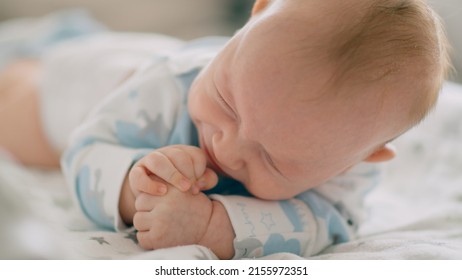 Close-up Face Of Infant Crying. Caucasian Baby Yelling. Child Crying. Slow Motion Video Of A Little Newborn In A Bad Mood