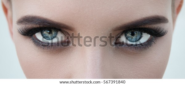 close-up face of pretty girl with beautiful big\
blue eyes, big eyelashes and\
eyebrows