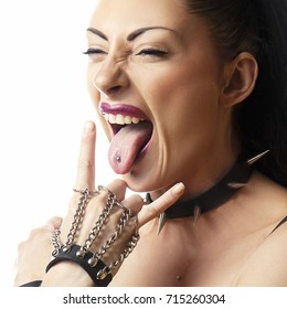 Close-up face of punk girl with piercing in tongue