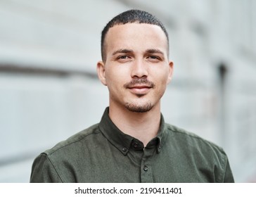 Closeup Face Of A Serious, Motivated And Ambitious Man Standing Outside In A City, Town Or Downtown Alone. Portrait, Headshot And Face Of Social Worker Or Volunteer Looking Forward With Trust Or