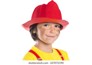 Closeup face of smiling boy wearing firefighter helmet isolated on white background. Happy cute boy smiling and looking at camera with his face dirty soot.