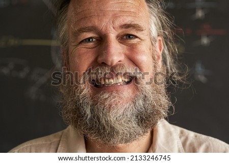 close-up of the face of the smiling middle-aged man looking into the camera.