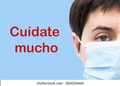 Close-up Face Of Tired Young Brunette Woman In Medical Disposable Mask On Blue Background. Spanish Inscription 