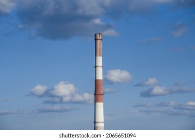 Close-up Factory Brick Chimney. Pipe Cogeneration Plant On The Sky Background. Ambient Air Pollution Industrial Emissions.