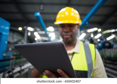 Close-up of factory worker using digital tablet in the factory