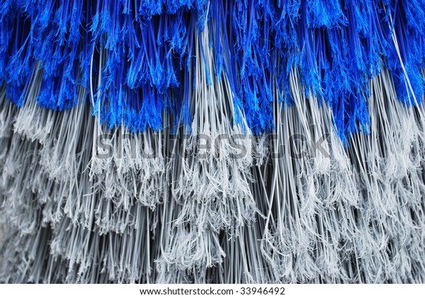 Closeup facture of blue and gray car wash\
brush as a background