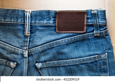 Close-up Faded Blue Jeans Back Pocket With Blank Leather Tag