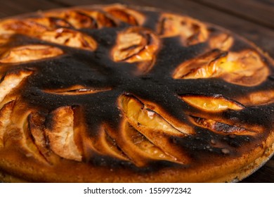 Close-up Failed Apple Pie. Burnt On Top And The Dough Did Not Rise During Baking. Textured Burnt Pie Crust
