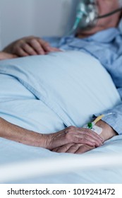 Close-up Of Family Member Comforting Dying Patient In The Hospital