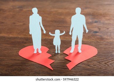 Close-up Of A Family Paper Cut On Broken Heart At Wooden Desk - Powered by Shutterstock