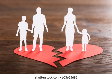 Close-up Of A Family Paper Cut On Broken Heart At Wooden Desk - Powered by Shutterstock