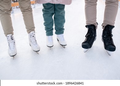 Close-up Of Family Of Three Wearing Skates Standing On Skating Rink They Going To Skate