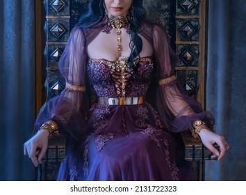 Close-up Fantasy Portrait Woman Queen Sits On Antique Royal Throne. No Face. Beautiful Vintage Majestic Luxury Medieval Tulle Long Dress. Gold Jewelry, Necklace, Brooch. Backdrop Gray Curtains Drapes 