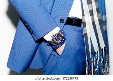 Closeup Fashion Image Of Luxury Watch On Wrist Of Man.body Detail Of A Business Man.Man's Hand In Blue Pants Pocket Closeup At White Background.Man Wearing Blue Jacket And White Shirt.Not Isolated