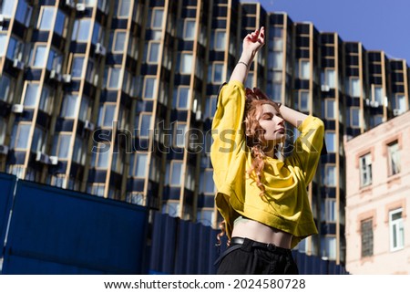 Similar – Young blonde woman in a sunny day in the city