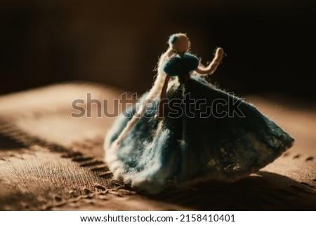A closeup of a fashionable female toy on a brown surface