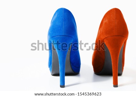 Closeup of fashionable high heels red and blue shoes isolated on white background. Blue color woman shoe on floor. Shopping and fashion concept. Copy space. Selective focus