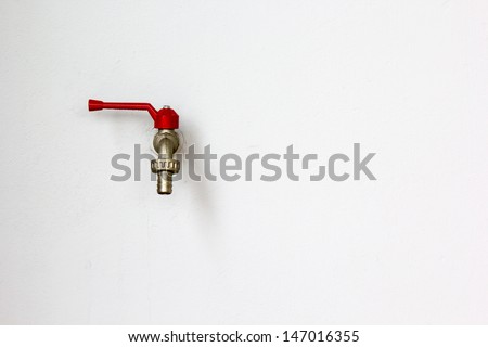 Closeup faucet on concrete white wall background
