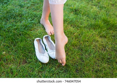 Close-up To The Feet Of A Balerina Dancing On The Grass