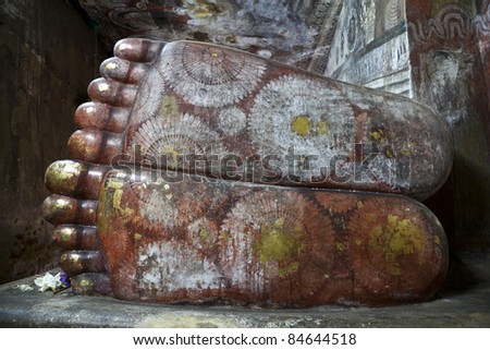 closeup feet of reclining buddha in dambulla cave, srilanka