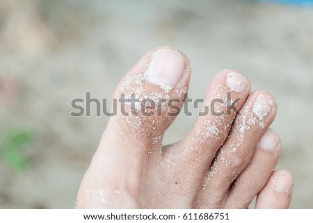 Closeup of feet and sand 
