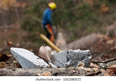Close-up of felling wedges and forestry worker in background - Powered by Shutterstock