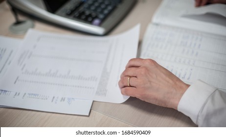 
Close-up of female accountant hands, calculates and research the financial data position of the company and planning the economy financial profit or loss of bank accounts
