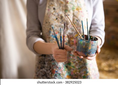 Closeup Of Female Artist Hand Holding Paintbrush
