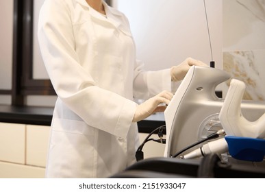 Close-up Of A Female Beautician Aesthetician Adjusting Functions On Monitor Of A Medical Equipment For Radiofrequency Therapy And Active Thermolysis In Wellness Spa