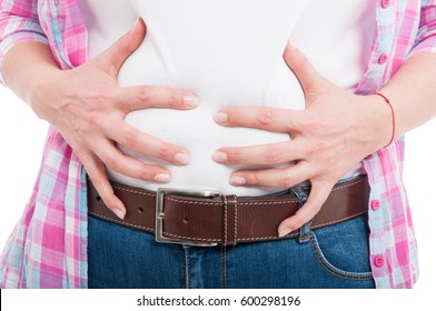 Close-up of female with bloated belly as flatulence concept isolated on white background