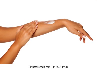 closeup of female dark skinned hands applying hand cream on white background - Shutterstock ID 1165041958