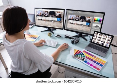 Close-up Of A Female Designer Working On Multiple Computer At Workplace - Shutterstock ID 1042807015