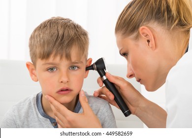 Close-up Of Female Doctor Examining Boy's Ear With An Otoscope - Powered by Shutterstock