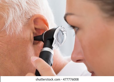 Close-up Of Female Doctor Examining Patient's Ear With Otoscope - Powered by Shutterstock