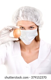 Close-up Of Female Doctor Or Scientist With Egg On A White Background