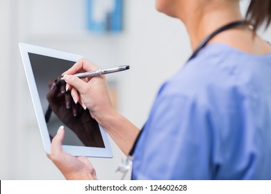 Close-up of female doctor using digital tablet