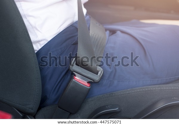 Closeup of\
female driver with fastened seat\
belt